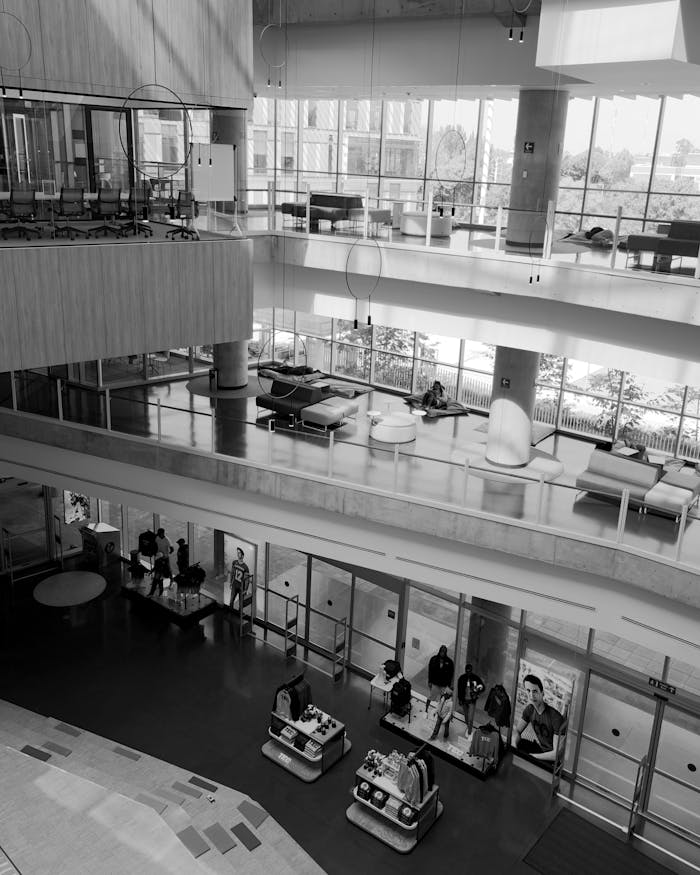 Black and white photo of a large lobby with people